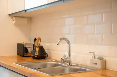 a kitchen counter with a sink in a kitchen at Green Relax Leones in Valencia
