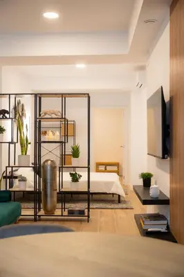 a living room with a bed and some plants at Green Relax Leones in Valencia