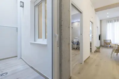 an open hallway with a room with a table at ApartUP Ca La Leni Beach I in Valencia