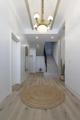 a large living room with a chandelier and a rug at ApartUP Ca La Leni Beach III in Valencia