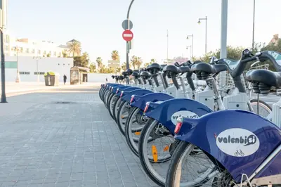 a row of blue bikes parked in a parking lot at ApartUP Ca La Leni Beach III in Valencia