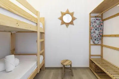 a room with two bunk beds and a chair at ApartUP Ca La Leni Beach II in Valencia