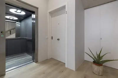 a hallway with a door and a potted plant at ApartUP Ca La Leni Beach II in Valencia