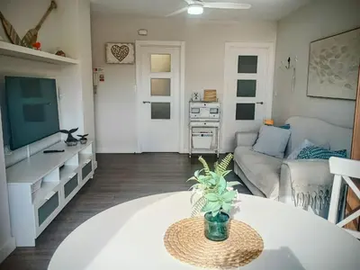 a living room with a table and a couch at ROYAL BEACH - Appartment with sea view & terrace in Faro de Cullera
