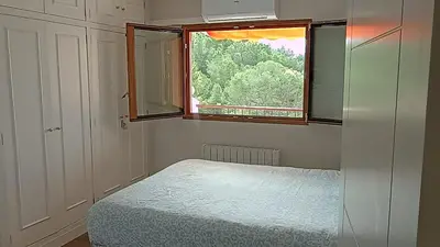 a small bedroom with a bed and a window at ROYAL BEACH - Appartment with sea view & terrace in Faro de Cullera