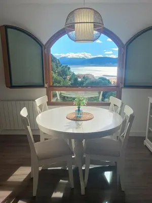 a white table and chairs in a room with a large window at ROYAL BEACH - Appartment with sea view & terrace in Faro de Cullera