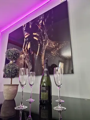 a bottle of wine and four wine glasses on a table at Apartamento playa Moncofa-Chilches in Chilches