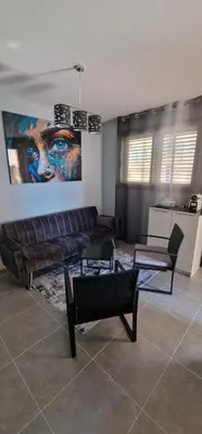 a living room with a couch and a painting on the wall at Apartamento playa Moncofa-Chilches in Chilches