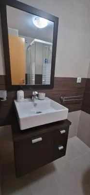 a bathroom with a sink and a large mirror at Apartamento playa Moncofa-Chilches in Chilches