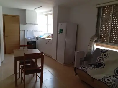 two twin beds in a room with a window at Apartamentos Torresmar in Altura