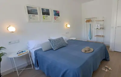 a bedroom with a blue bed with a hat on it at Piso nuevo y luminoso ESTANCIAS DE TEMPORADA Mín 12 noches in Valencia