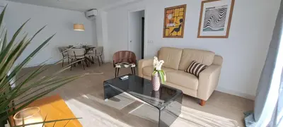 a living room with a couch and a table at Piso nuevo y luminoso ESTANCIAS DE TEMPORADA Mín 12 noches in Valencia