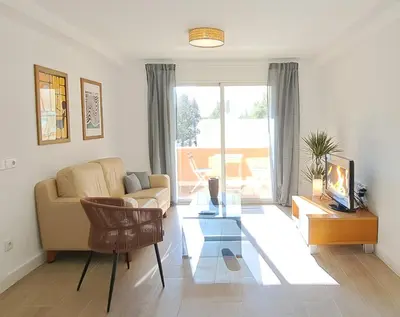 a living room with a couch and a table at Piso nuevo y luminoso ESTANCIAS DE TEMPORADA Mín 12 noches in Valencia