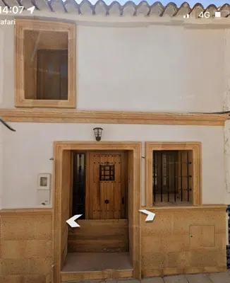 two doors of a house with arrows pointing into it at Casa Rural El Molino in Macastre