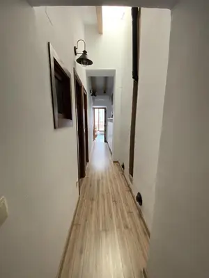 a hallway with white walls and a wooden floor at Casa Rural El Molino in Macastre