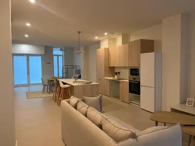 a large living room with a couch and a kitchen at Casa Ramona Ruzafa Valencia Centro in Valencia
