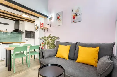 a living room with a gray couch and a table at Marie Curie Flats, Lovely Loft in Valencia