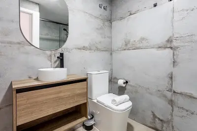 a bathroom with a toilet and a sink and a mirror at Marie Curie Flats, Lovely Loft in Valencia