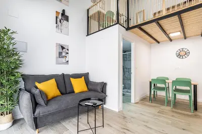 a living room with a gray couch and green chairs at Marie Curie Flats, Lovely Duplex 2 in Valencia