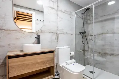a bathroom with a toilet and a sink and a shower at Marie Curie Flats, Lovely Duplex 2 in Valencia