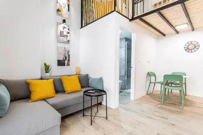 a living room with a couch and a table at Marie Curie Flats, Lovely Duplex 3 in Valencia