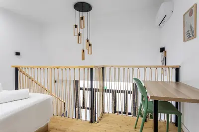 a dining room with a wooden table and a desk at Marie Curie Flats, Lovely Duplex 3 in Valencia