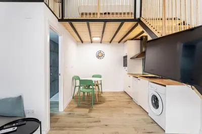 a kitchen and dining room with a table and chairs at Marie Curie Flats, Lovely Duplex 3 in Valencia
