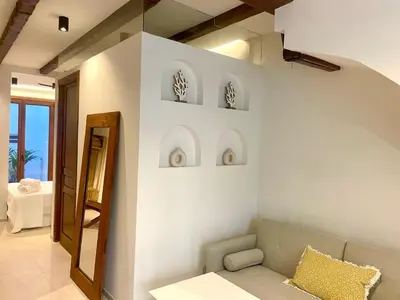 a living room with a couch and a mirror at Pepitas House in Valencia
