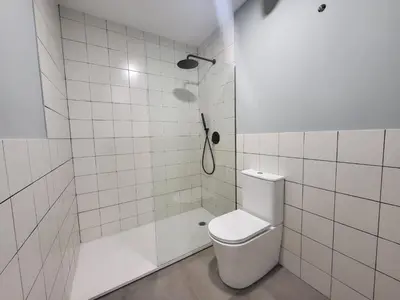 a white bathroom with a toilet and a shower at Apartamento Cienciasmar in Valencia