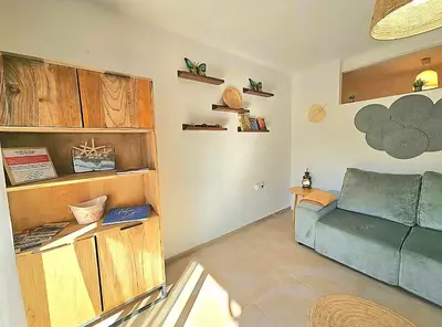 a living room with a blue couch in a room at Urban loft Valencia playa in Puebla de Farnals
