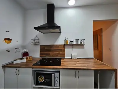 a kitchen with a stove and a counter top at Urban loft Valencia playa in Puebla de Farnals