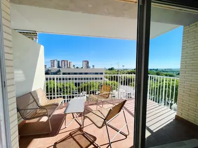 a balcony with chairs and a table on a balcony at Marinao Apartment in Playa Pobla de Farnals