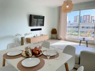 a living room with a table with a plate of fruit on it at Marinao Apartment in Playa Pobla de Farnals