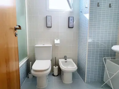 a bathroom with a toilet and a sink at Marinao Apartment in Playa Pobla de Farnals