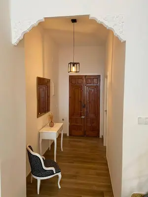 a hallway with a table and chairs and a door at Casa La Culle in Favareta