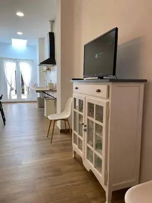 a living room with a tv on top of a cabinet at Casa La Culle in Favareta