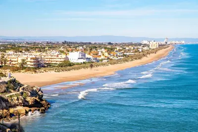 a view of a beach with buildings and the ocean at Casa La Culle in Favareta