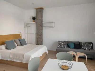 a living room with a bed and a couch at Loft nuevo cerca de Ruzafa in Valencia