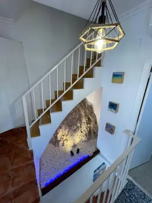 a staircase with a rock mural on the wall at Casa Rural Buñol Ca Maruja-Experiencia Unica in Buñol