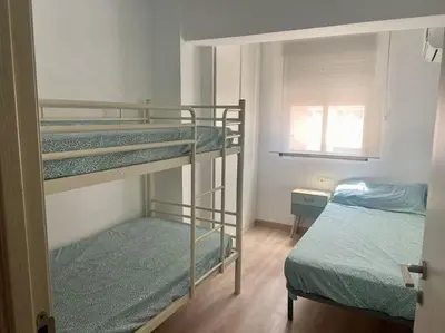 a room with two bunk beds and a bed at Apartamento en Cullera in Cullera