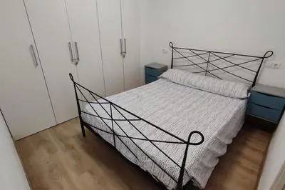 a bedroom with a bed with a metal frame at Apartamento en Cullera in Cullera