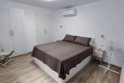 a bedroom with a bed and a desk and a chair at Apartamento en Cullera in Cullera