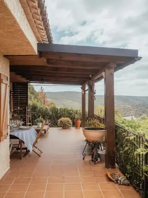 a patio with a table and a view of the mountains at Casa Marla, Siete Aguas in Siete Aguas