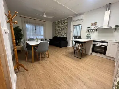 a kitchen and living room with a table and chairs at BajoPlaya in Burriana