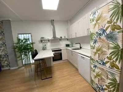 a kitchen with white cabinets and a counter top at BajoPlaya in Burriana