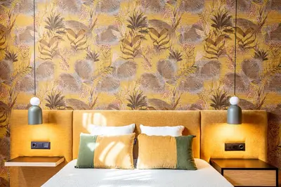 a bedroom with a bed with a yellow wall at Saman Hotel Boutique in Valencia