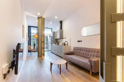 a living room with a couch and a table at Mestalla Flats by Nomad Host in Valencia