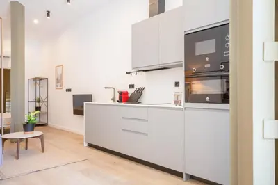 a kitchen with white cabinets and a microwave at Mestalla Flats by Nomad Host in Valencia