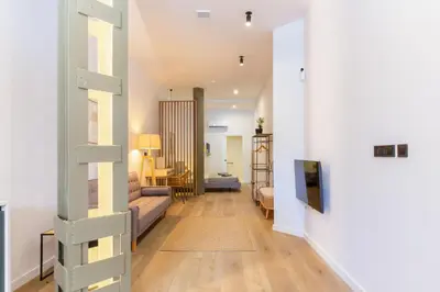 a hallway with a couch and a living room at Mestalla Flats by Nomad Host in Valencia