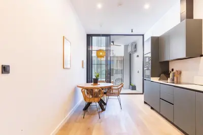 a kitchen with a table and chairs in a room at Mestalla Flats by Nomad Host in Valencia